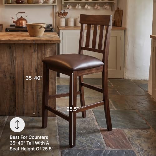 Signature Design by Ashley Haddigan Upholstered Barstool, 2 Count, Slat Back Design, Cushioned Seat, Wood, 25.5" H, Dark Brown | Easy-clean faux leather cushioned seat, Casual farmhouse wood slat back design, 25.6-inch seat height for kitchen islands - co